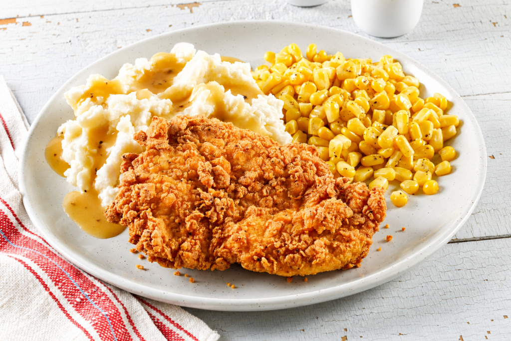 Dinner Bell Plates, Crispy fried chicken served with creamy mashed potatoes and gravy, seasoned sweet corn and homestyle sides.