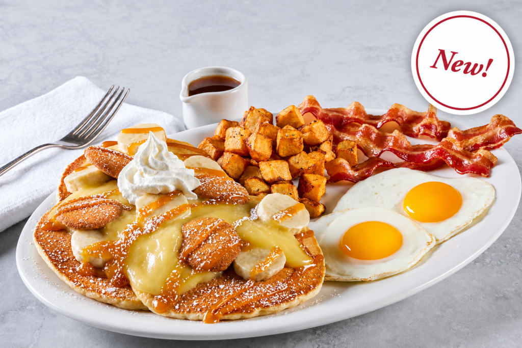 Banana pudding pancakes topped with banana slices, vanilla wafers, whipped cream and caramel, served with two eggs, crispy bacon and seasoned home fries.