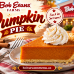 Slice of Bob Evans-style pumpkin pie topped with cinnamon-dusted whipped cream on a plate with autumn decorations.